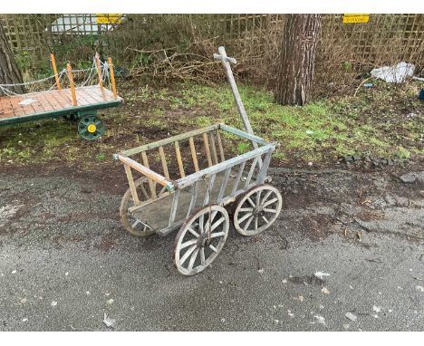 A vintage wooden dog cart with metal strapping and T-handle, length 111cm.