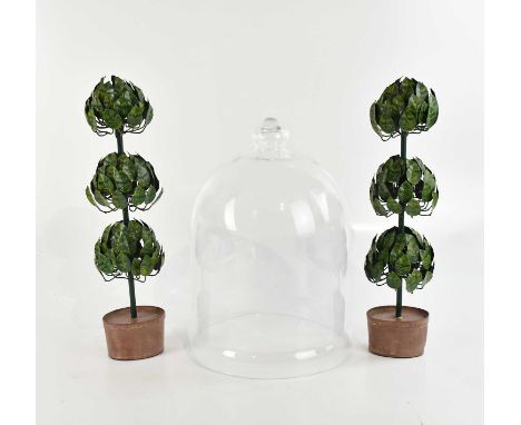 A pair of modern painted metal ornaments, modelled as topiary bushes, height 47cm, with a glass cloche, a modern table, and a