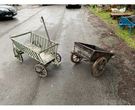 A vintage green painted wooden dog cart, length 156cm, and a wooden cart (2).