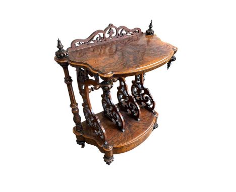 A Victorian walnut serpentine fronted Canterbury whatnot, with carved gallery back above three divisions and base drawer, wid