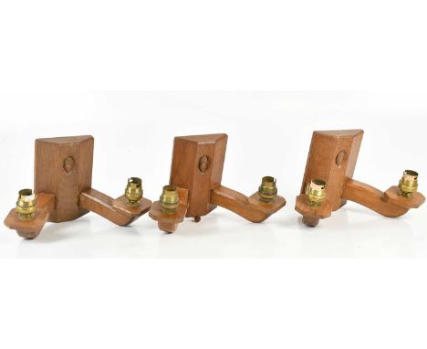ALAN GRAINGER ‘ACORN MAN’; three carved oak twin branch wall lights, each decorated with an acorn, height 15cm (3).Condition 