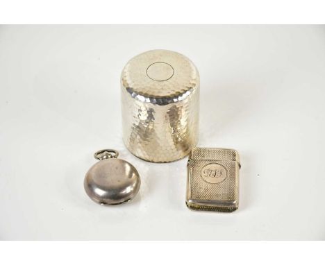 A hallmarked silver inkwell of cylindrical form with planished decoration, Chester, marks rubbed, with glass liner, a hallmar