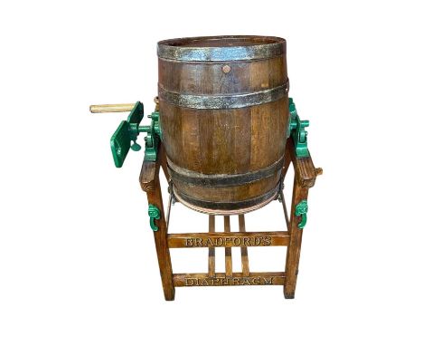 A late 19th/early 20th century coopered oak and cast iron milk churn on stand, height 112cm.