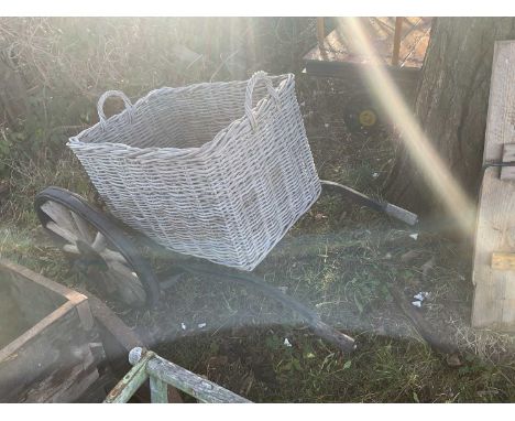 A vintage iron framed pull cart with associated wicker basket, length 122cm.