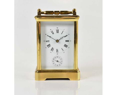 A 19th century French brass cased repeating carriage clock, the enamel dial set with Roman and Arabic numerals and subsidiary