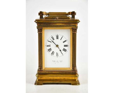GOLDSMITHS CO; a brass cased carriage clock with white enamel dial set with Roman numerals, height 18cm, with case.