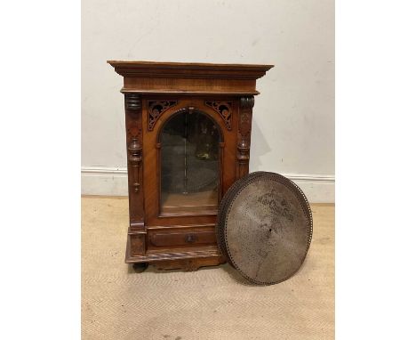 A Victorian walnut cased symphonium with single glazed door, with ten discs, height 96cm.Condition Report: Age related wear, 