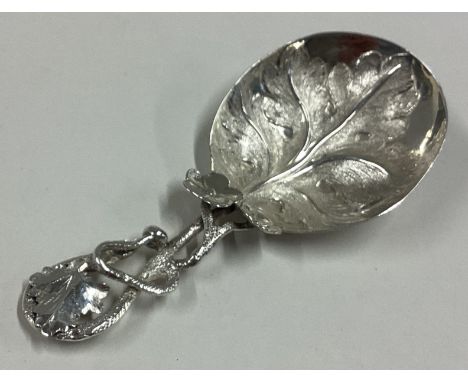 An attractive cast Victorian silver caddy spoon with leaf decoration. Birmingham. Approx. 15 grams. Est. £60 - £80.
