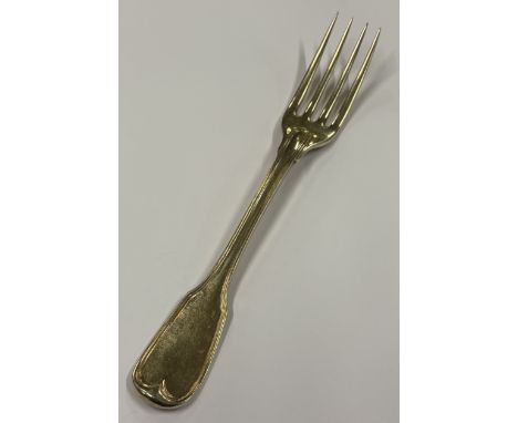 An 18th Century French silver gilt fork with crested decoration. Approx. 62 grams. Est. £60 - £80.