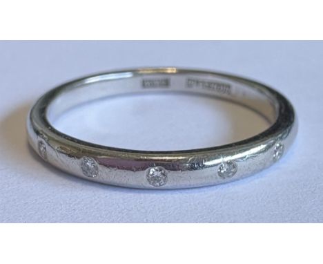 A platinum and diamond five-stone ring. Approx. ring size K. Approx. 5 grams. Est. £80 - £120.