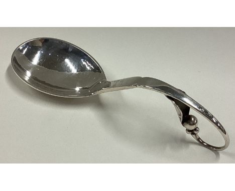 GEORG JENSEN: A stylish silver caddy spoon of typical form. Numbered 21 to reverse. Approx. 38 grams. Est. £60 - £80.
