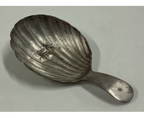 A George III silver caddy spoon with fluted bowl. Approx. 5 grams. Est. £10 - £20.