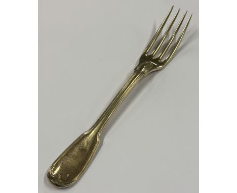 An 18th Century French silver gilt fork with crested decoration. Approx. 62 grams. Est. £60 - £80.