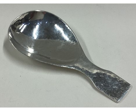 LIBERTY & CO: A stylish silver caddy spoon of textured form. Numbered 3183 to reverse. Sheffield. Approx. 24 grams. Est. £60 