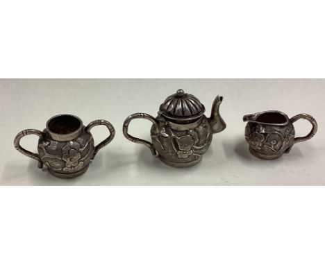 A 19th Century Chinese export silver three-piece toy tea set. Approx. 31 grams. Est. £80 - £120.