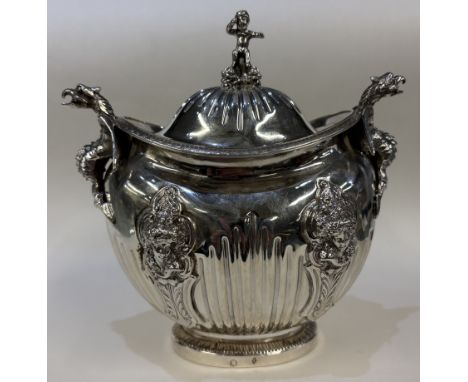 A 19th Century silver figural tea caddy / sugar box and cover with cast dragon handles and embossed cherub decoration. Approx