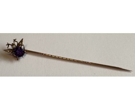 A gold and amethyst stick pin. Approx. 1 gram. Est. £20 - £30.