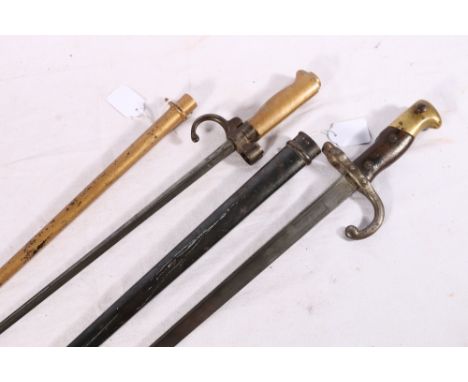 French 1886 pattern bayonet with brass hilt and hooked quillon in scabbard and a French 1874 pattern bayonet with T form blad