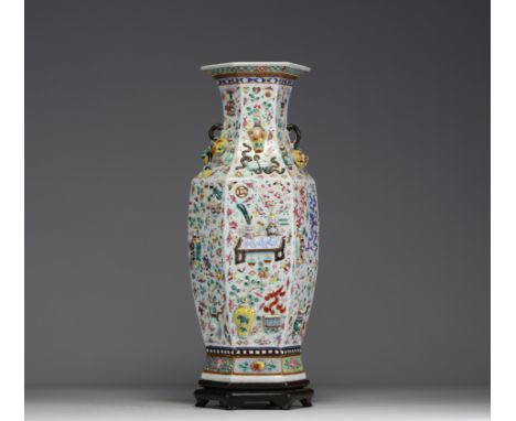 China - A rare pink family polychrome porcelain vase with relief decoration of antique domestic objects, floral and fruit mot