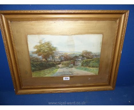 A framed and mounted coloured lithograph depicting two figures walking the village lane with homestead's in the distance. Uns