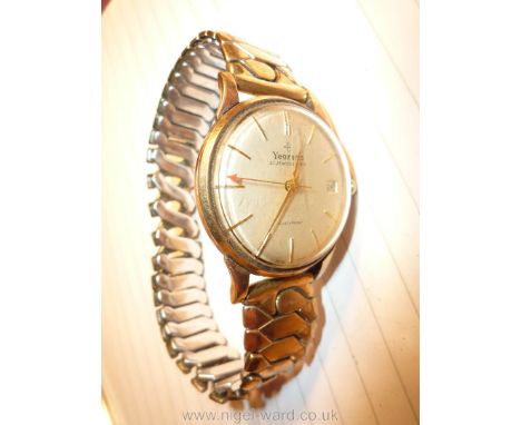 A yellow cased ''Yeoman 21 jewel level Shockproof Swiss Made'' gentleman's Wristwatch, 31 mm diameter, the cream satin finish