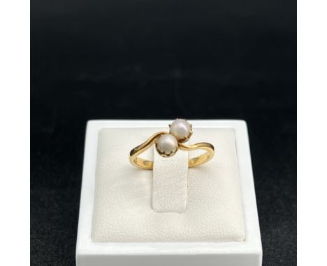 An 18ct yellow gold pearl twist ring,
size L,
2.6 grams in weight,