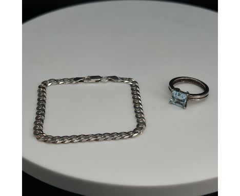 A silver aquamarine ring and a silver curb bracelet,
ring is size P,
bracelet is 7 inches of solid links,
total weight is 9.8