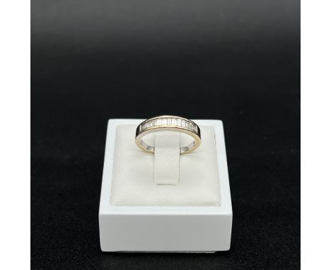 An 18ct white gold 0.50ct channel set emerald cut diamond ring,
3.8 grams in weight approx,
hallmarked,
size M,
will require 