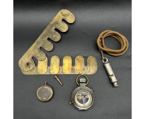 A mixed lot of military memorabilia, military compass with broken glass, button guard by Gennenes and Co London, trench art l