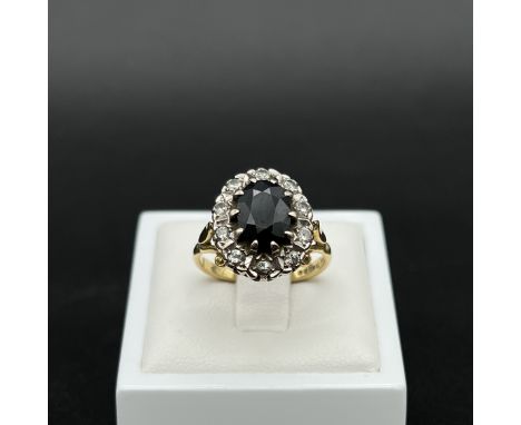 An 18ct yellow gold sapphire and diamond dress ring,
6.4 grams in weight approx,
large sapphire 10mm x 6mm,
set with 10 diamo