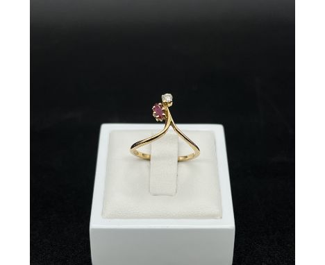 An 18ct yellow gold ruby and diamond ring,
size N,
2.1 grams in weight