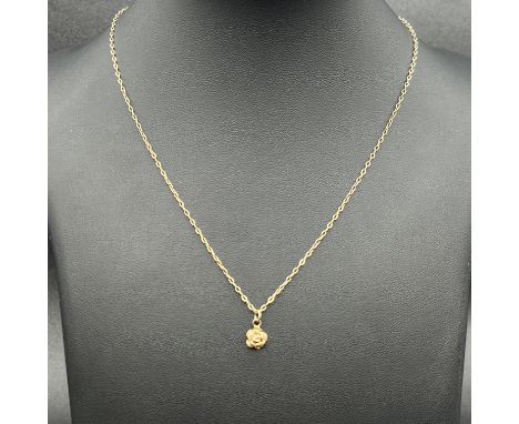 A 9ct yellow gold rose pendant and chain,
chain is 18 inches long,
1.5 grams in weight,