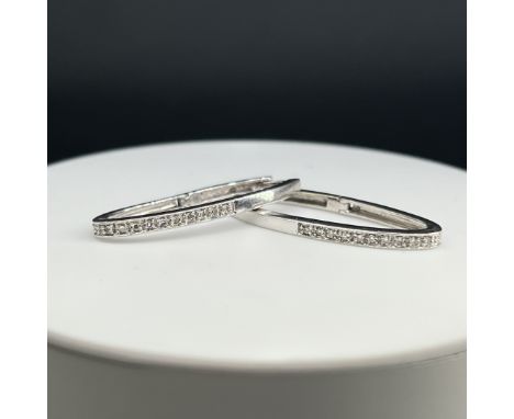 A pair of 18ct white gold diamond earrings,
3.6 grams in weight,
unhallmarked but tested as 18ct,