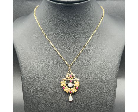 A 9ct yellow gold brooch pendant set with ruby opal and pearl,
brooch is unhallmarked and testing at 15ct and the pin bar is 