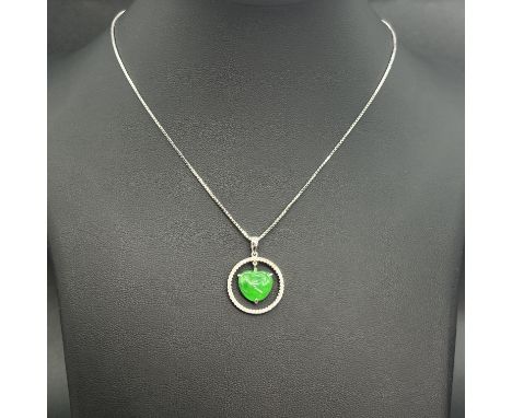 An 18ct white gold jade and diamond pendant,
hallmark is AU750 75% is gold 25% is other metals,
hallmarked 0.25ct diamonds,
1
