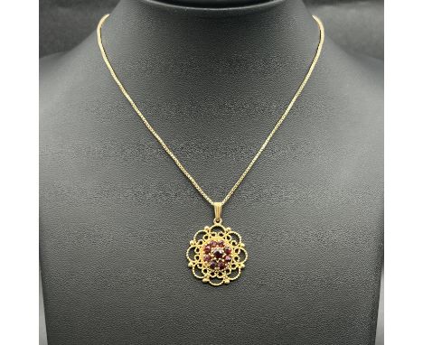 A 9ct yellow gold garnet pendant and chain,
both hallmarked 9ct,
chain is 16 inches long,
pendant is 24mm,
6.6 grams in weigh