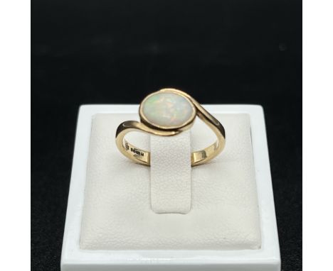 A 9ct yellow gold opal twist ring,
size P,
2.9 grams in weight approx,