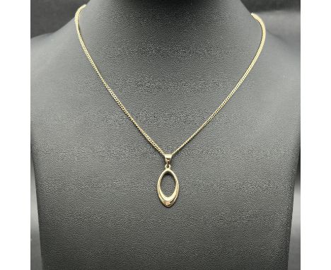 A 9ct yellow gold curb chain and pendant,
chain and pendant 9ct hallmarked,
chain is 18 inches long,
pendant is 27mm x 10mm,
