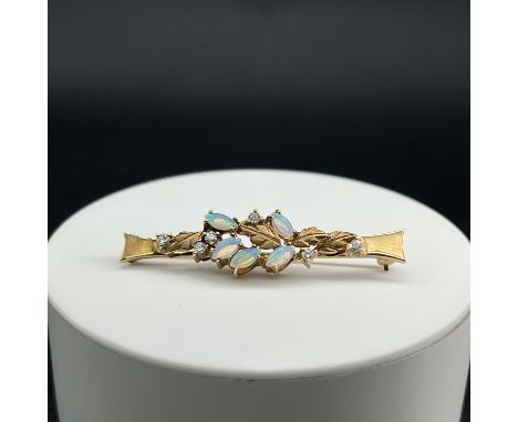 A 9ct yellow gold opal and diamond brooch,
4.94 grams in weight,
50mm x 10mm,