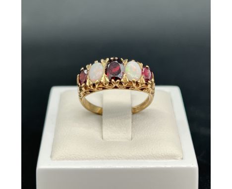 A 9ct yellow gold antique opal and garnet ring,
size N,
3.31 grams in weight,