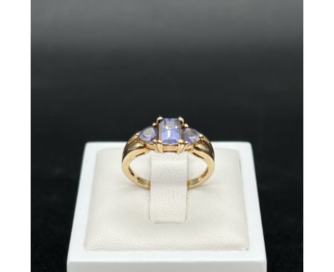 A 9ct yellow gold tanzanite dress ring,
an emerald cut tanzanite stone with triangle tanzanite at the shoulders,
size L,
2.4 