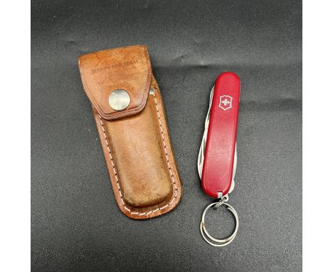 A Swiss army knife in a leather case