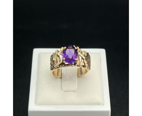 A 9ct yellow gold amethyst designer made ring,
size leading edge M,
10mm wide,
5.3 grams in weight&nbsp;