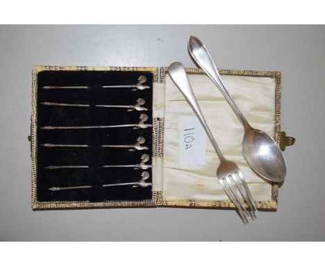 Set of six silver chicken cocktail sticks together with a silver fork and spoon