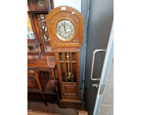 A 1930s oak cased granddaughter clock. 