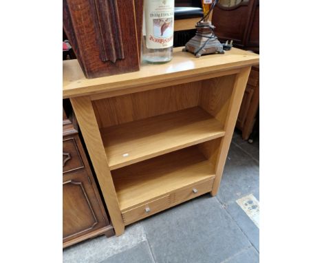 A modern light oak bookcase. Dimensions- height 108cm, width 88cm and depth 38cm.Condition- good.