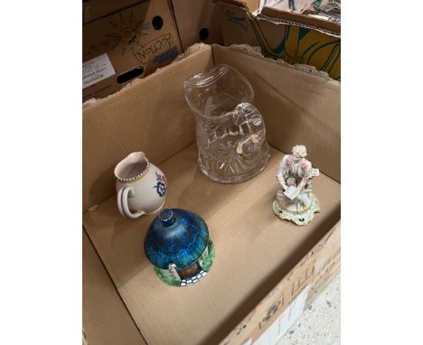 A box containing an etched glass jug, a small Poole pottery jug, a Crown Devon jam pot in the shape of a cottage and a German