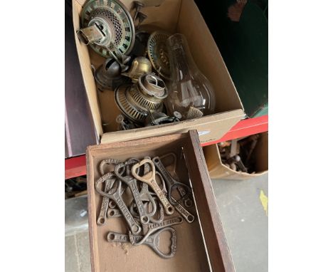 A box of vintage metal bottle openers and a box of lamp's parts. 
