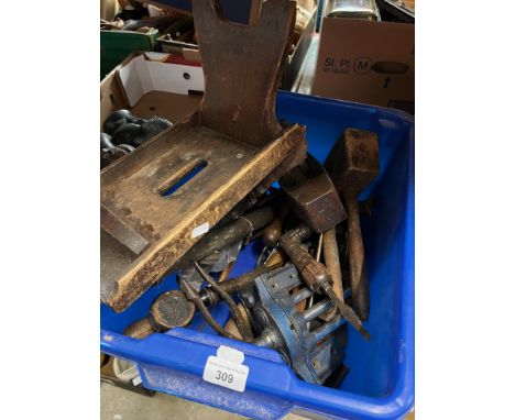 A box of tools to include a woodworking vice, a small stool, plane, etc. 