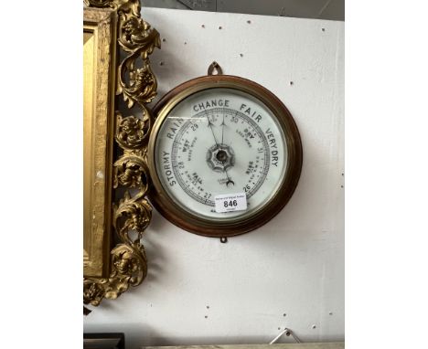 A brass aneroid barometer signed Gamage London, mounted on oak. 